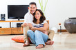 Asian couple at home in their living room