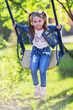 Pretty little girl swinging on seesaw
