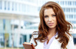 Attractive business women over modern street background