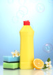 Dishwashing liquid with sponges and lemon with flowers