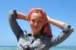 Beautiful redhead woman with scarf, having fun at the beach