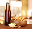 Crackers  and glass bottle of beverage, on bright background