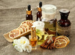 Bottles with ingredients for the perfume on burlap background