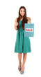 Photo: Young beautiful girl in green dress holding bright shopping Young beautiful girl in green dress holding bright shopping