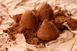 Chocolate truffles and cocoa, on brown background