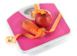 Photo: Apple and carrot on scales isolated on white Apple and carrot on scales isolated on white