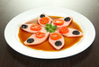 Small portion of food on big plate on wooden table