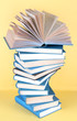 Spiral books on beige background