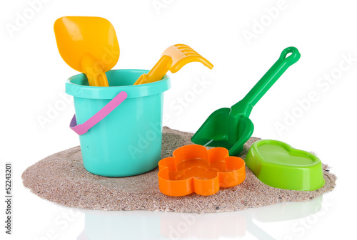 Photo: Children's toys on sand isolated on white Children's toys on sand isolated on white