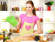 Photo: Young woman cooking in kitchen Young woman cooking in kitchen