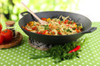 Noodles with vegetables on wok on nature background
