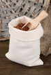 Grains in sack on wooden background