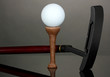 Golf ball and driver on grey background