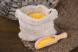 Photo: Grains in sack on wooden background Grains in sack on wooden background