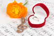 Treble clef, flower and box holding wedding ring