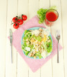 Caesar salad on blue plate, on color wooden background