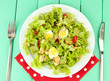 Caesar salad on white plate, on color wooden background