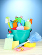 Cleaning items in bucket on  color background
