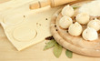 Raw dumplings and dough, on wooden table
