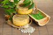 Foto: Hand-made soap and sea salt on grey bamboo mat Hand-made soap and sea salt on grey bamboo mat
