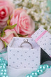 Roses and a ring on a white cloth