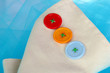 Three buttons on beige and blue cloth