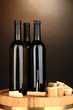 Wine and corks on barrel on brown background