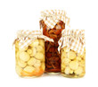 Delicious marinated mushrooms in glass jars, isolated on white