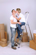 Photo: Young couple moving in new house Young couple moving in new house