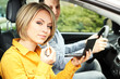 Portrait of young beautiful couple sitting in the car (woman