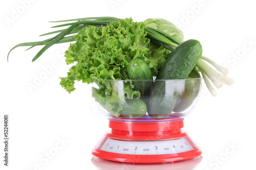 Photo: Fresh vegetables in scales isolated on white Fresh vegetables in scales isolated on white