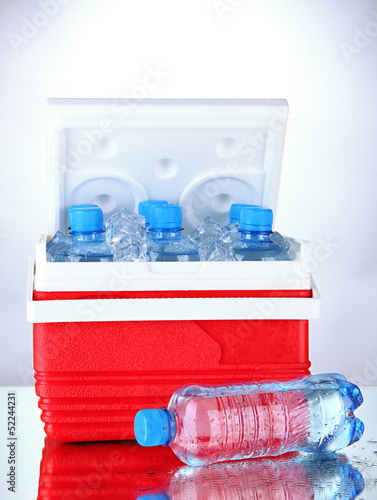 Photo: Traveling refrigerator with bottles of water and ice cubes, Traveling refrigerator with bottles of water and ice cubes,