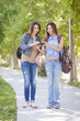 Young Adult Mixed Race Twin Sisters Sharing Cell Phone Experienc