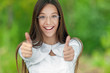 Foto: Smiling teenage girl picks up big thumbs up Smiling teenage girl picks up big thumbs up