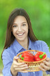 smiling teenage girl with basket of red peppers