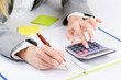 Hands working on the calculator