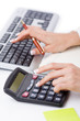 Photo: Hands working on the calculator Hands working on the calculator