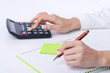 Foto: Hands working on the calculator Hands working on the calculator