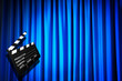 Movie clapper board against curtain