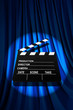 Movie clapper board against curtain