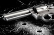Gun with bullet holes in glass