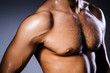 Muscular man in dark studio
