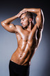 Muscular man in dark studio