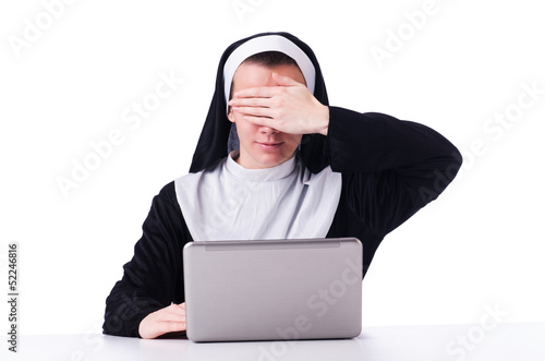 Photo: Nun working on laptop - religious concept Nun working on laptop - religious concept