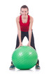 Young woman with ball exercising on white