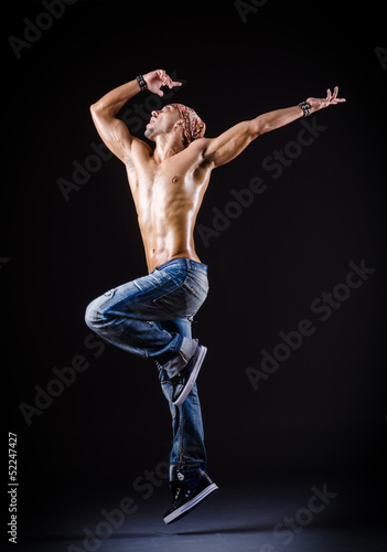 Photo: Dancer dancing in the dark studio Dancer dancing in the dark studio