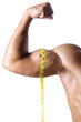 Muscular man measuring his muscles