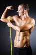 Muscular man measuring his muscles
