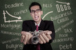 Angry businessman with hands chained at class