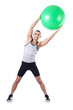 Man with swiss ball doing exercises on white